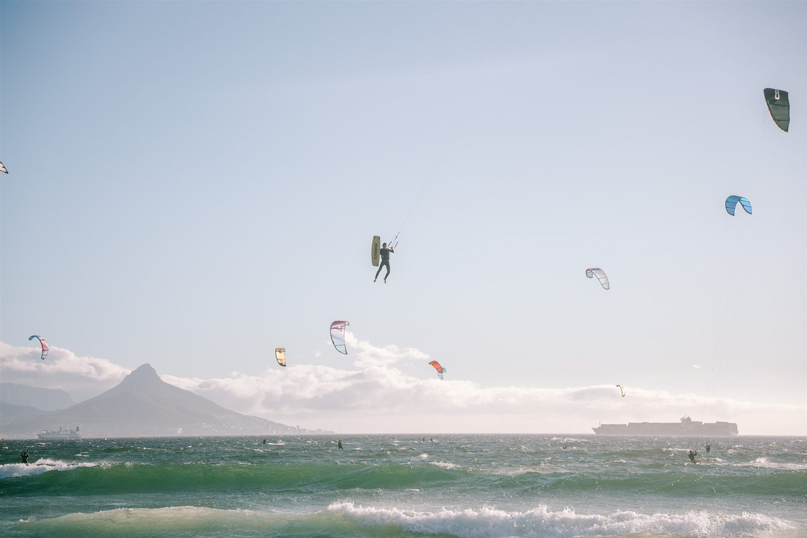 A big-air jump at Kite Beach with Lion's Head in the background