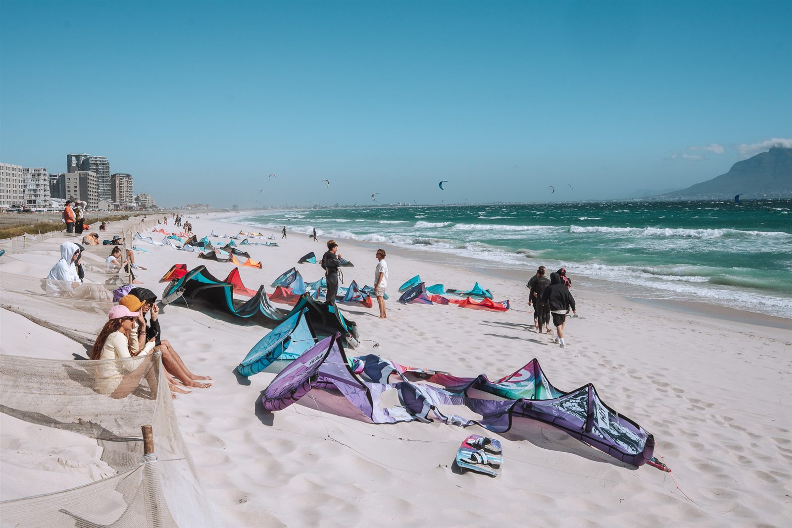 Kite Beach in Bloubergstrand on a windy afternoon, kites laid out on the sand