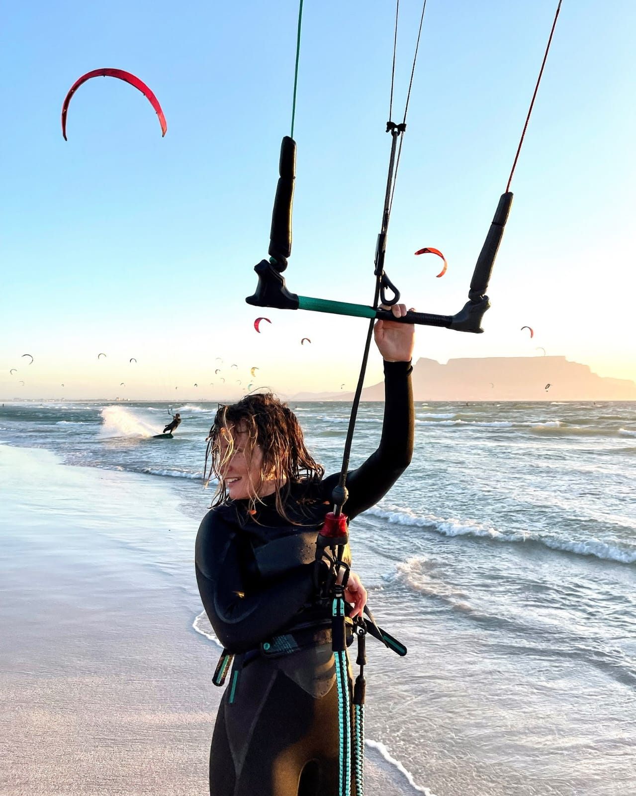 A kiter at sunset on Blouberg beach with Table Mountain behind